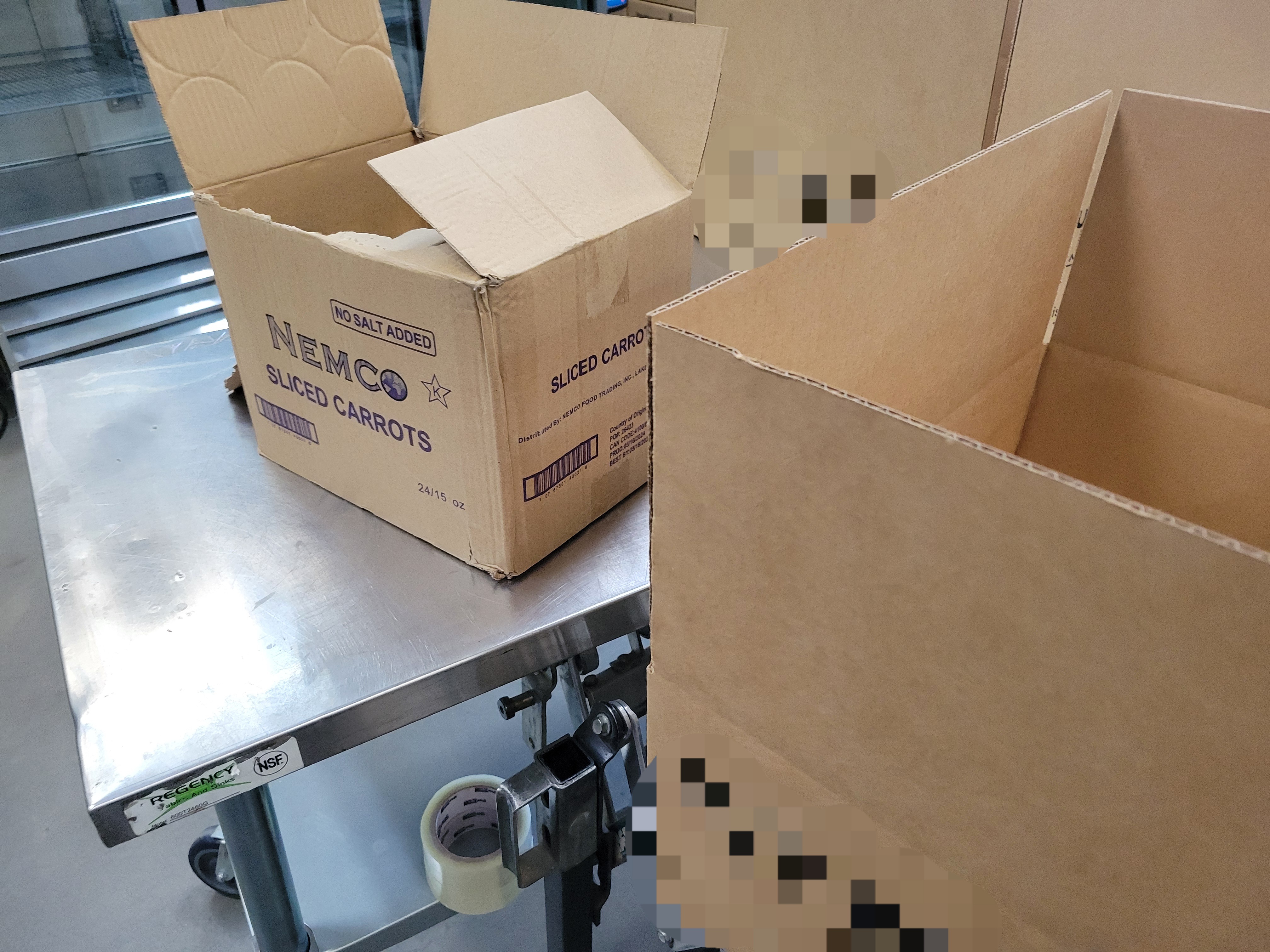 Cardboard boxes on metal table.